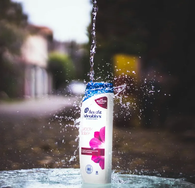 Head & Shoulders shampoo bottle splashing into water, shot for a product campaign
